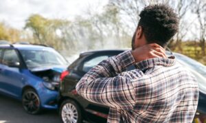 Man holding neck in pain after a car accident
