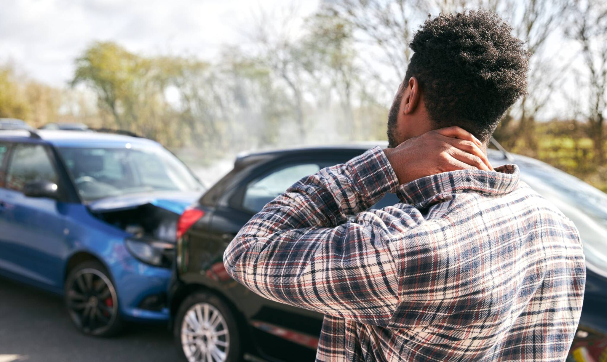 Man holding neck in pain after a car accident